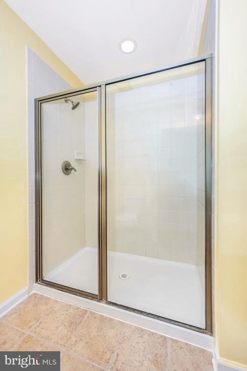 bathroom featuring tile patterned floors and a shower with door