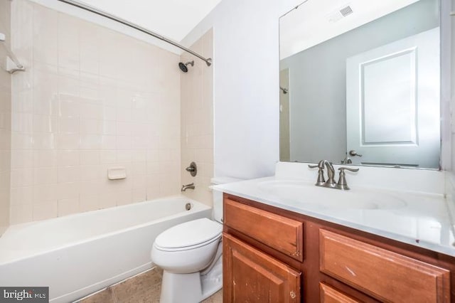 full bathroom with tile patterned floors, vanity, toilet, and tiled shower / bath combo