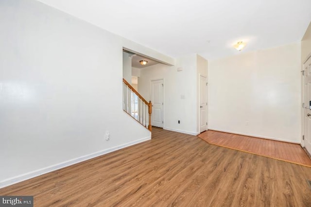 spare room featuring wood-type flooring