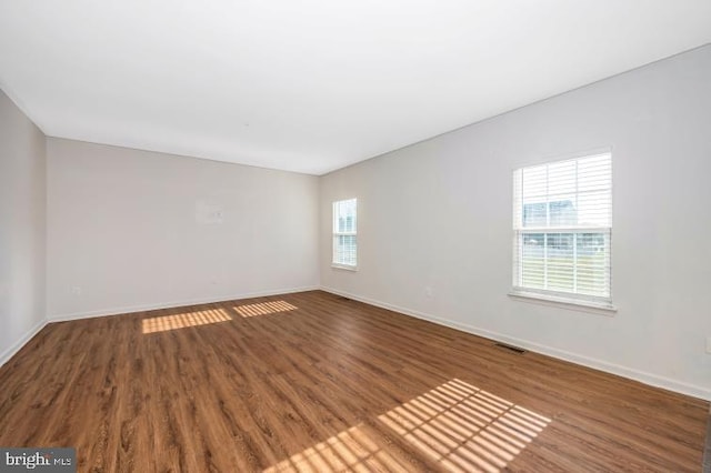 empty room with dark wood-type flooring