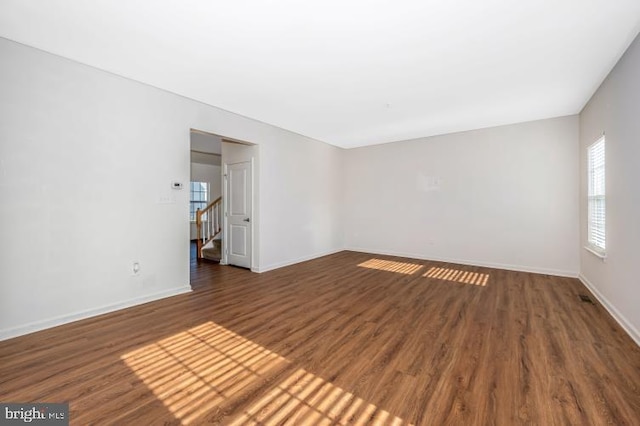 empty room featuring dark wood-type flooring