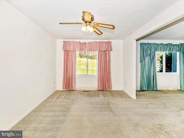 spare room with ceiling fan and carpet