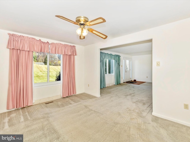 carpeted empty room with ceiling fan