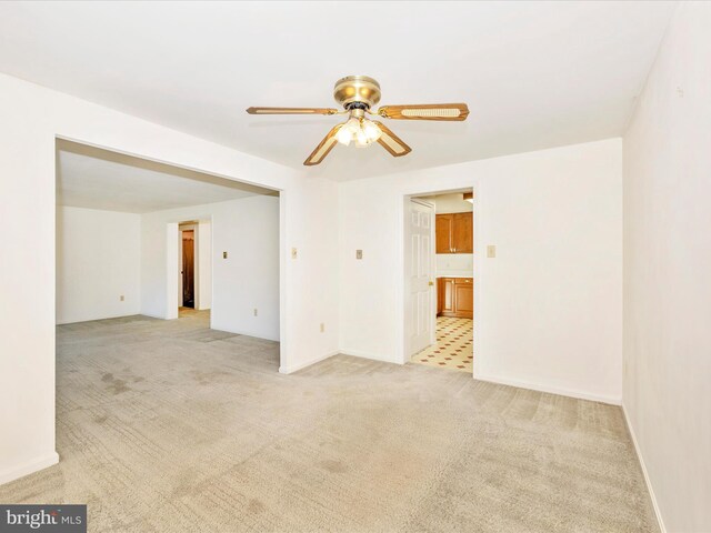 unfurnished room with ceiling fan and light colored carpet