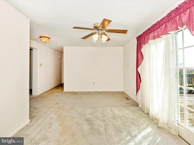 carpeted empty room with ceiling fan