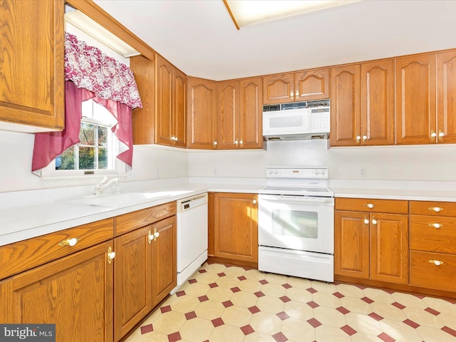 kitchen featuring sink and white appliances