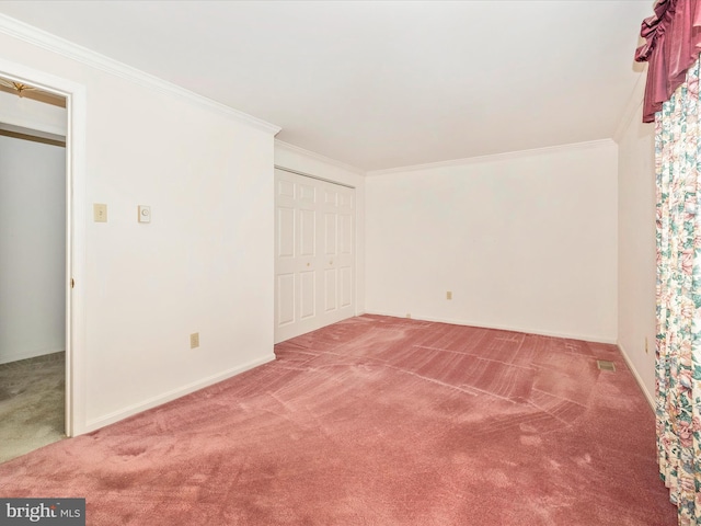 unfurnished bedroom featuring crown molding, carpet floors, and a closet