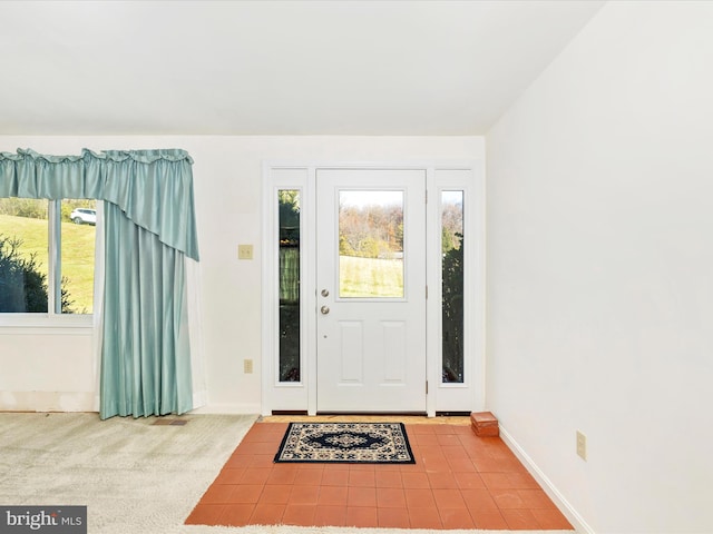 view of carpeted entrance foyer