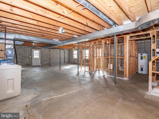 basement featuring water heater and washer / clothes dryer