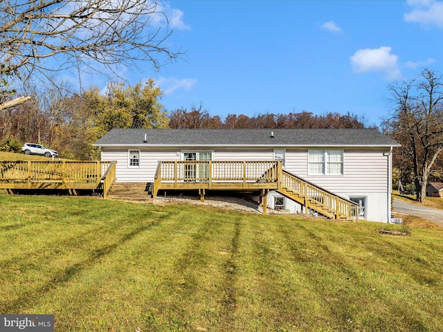 back of property with a wooden deck and a yard