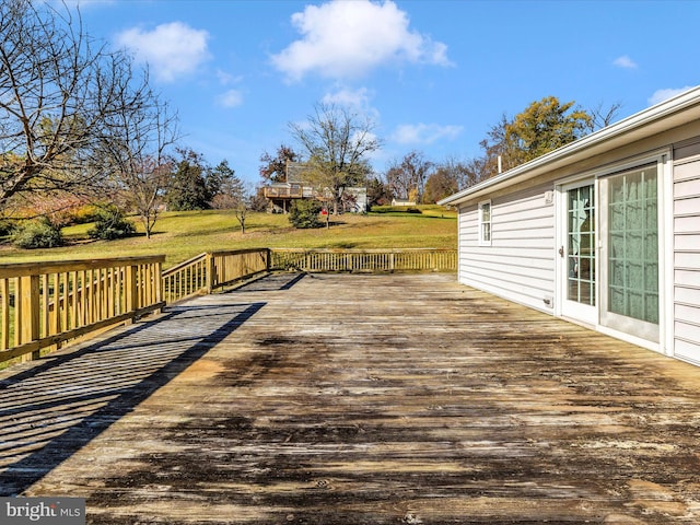 wooden deck featuring a yard