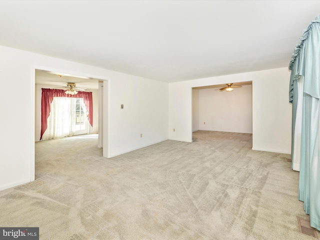 carpeted empty room featuring ceiling fan