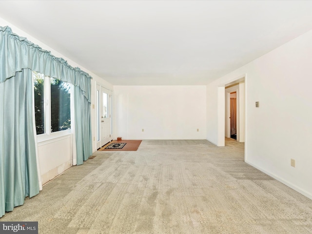 empty room featuring light colored carpet