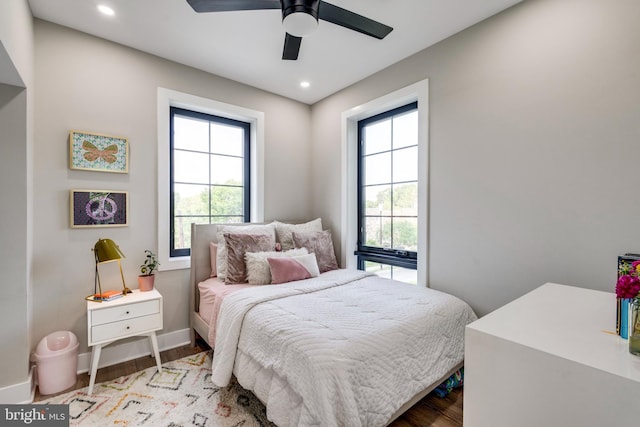 bedroom with multiple windows, ceiling fan, and light hardwood / wood-style flooring