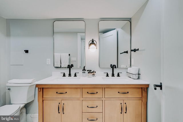 bathroom with toilet and vanity