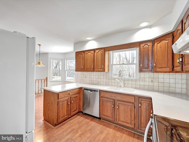 kitchen featuring dishwasher, sink, decorative light fixtures, decorative backsplash, and white fridge