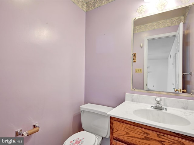 bathroom featuring toilet and vanity