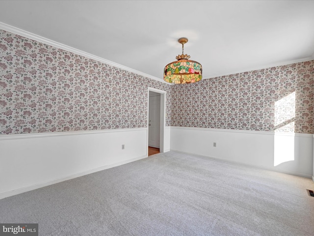 carpeted spare room with ornamental molding