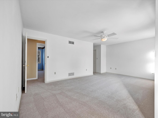 empty room with light colored carpet and ceiling fan