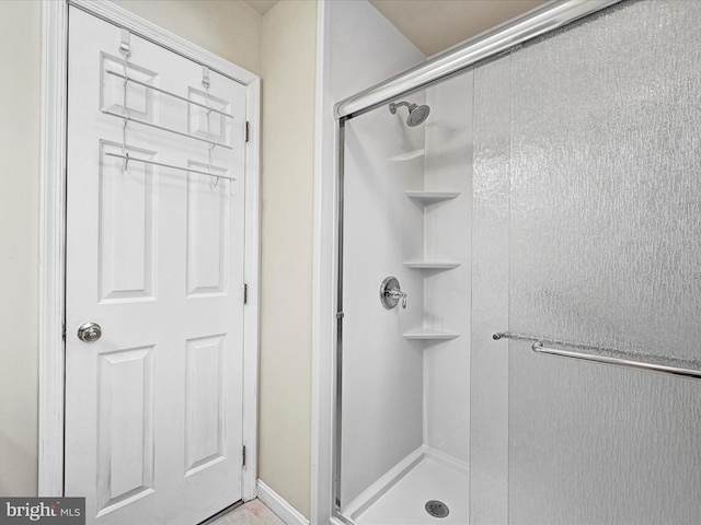 bathroom with a shower with shower door