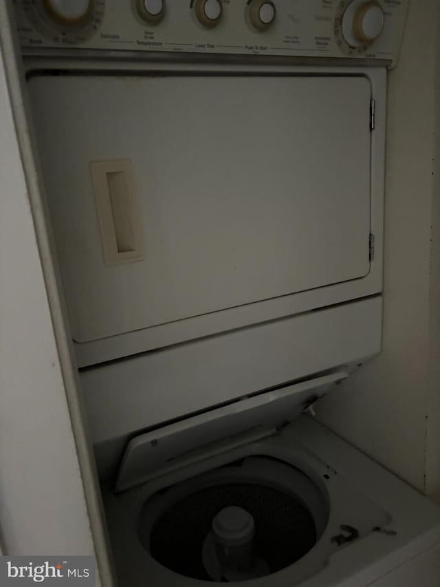 laundry area with stacked washer and clothes dryer
