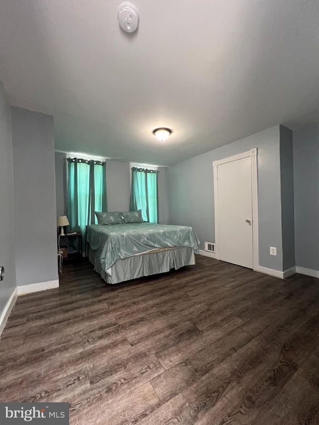 unfurnished bedroom featuring dark wood-type flooring