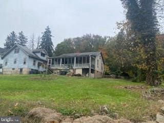 back of house with a lawn