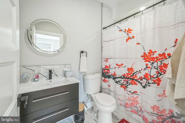 bathroom featuring vanity, curtained shower, and toilet