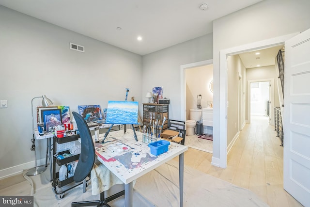 office space with wood-type flooring