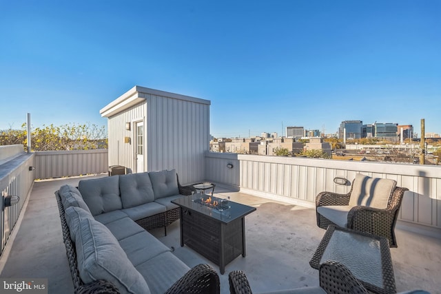 view of patio featuring an outdoor living space with a fire pit