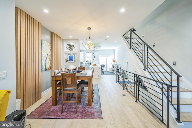 dining room featuring an inviting chandelier and light hardwood / wood-style flooring