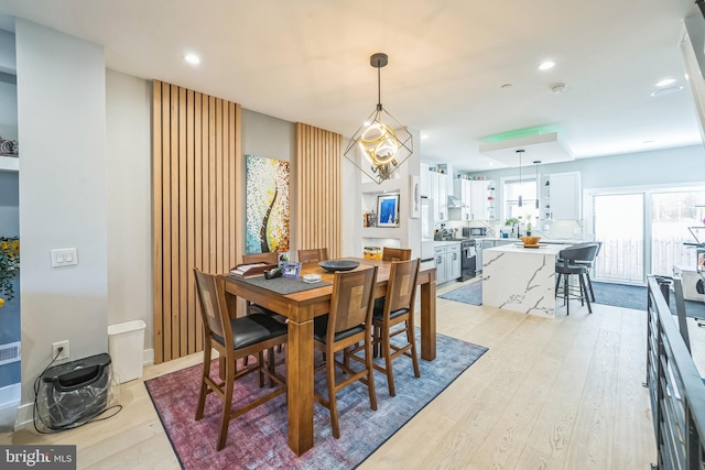 dining room featuring light hardwood / wood-style floors and a notable chandelier