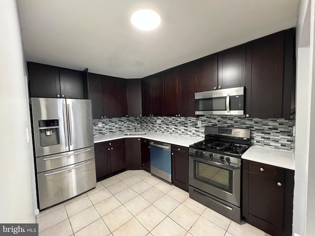 kitchen with stainless steel appliances, dark brown cabinetry, and decorative backsplash