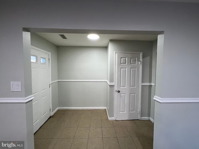 entryway with light tile patterned floors