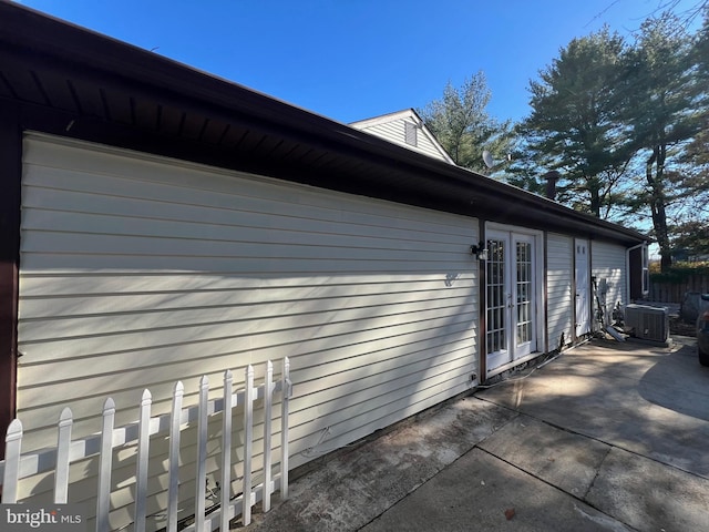 view of property exterior featuring central air condition unit and a patio