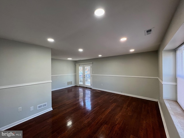 unfurnished room featuring french doors and dark hardwood / wood-style flooring