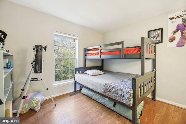 bedroom with hardwood / wood-style floors