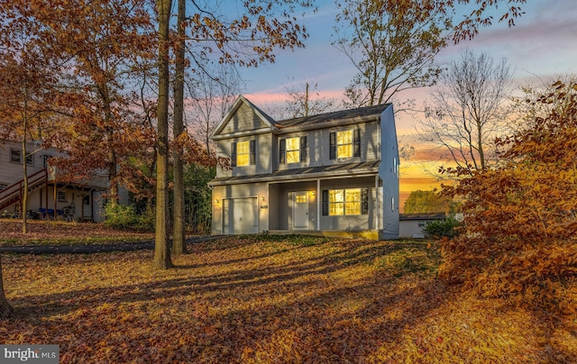 back house at dusk with a garage