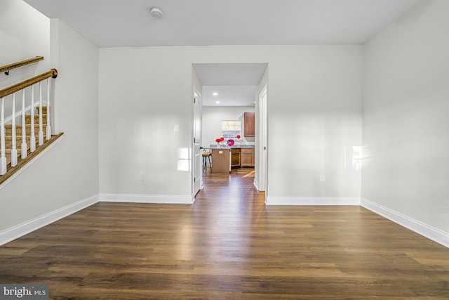 unfurnished room featuring dark wood-type flooring