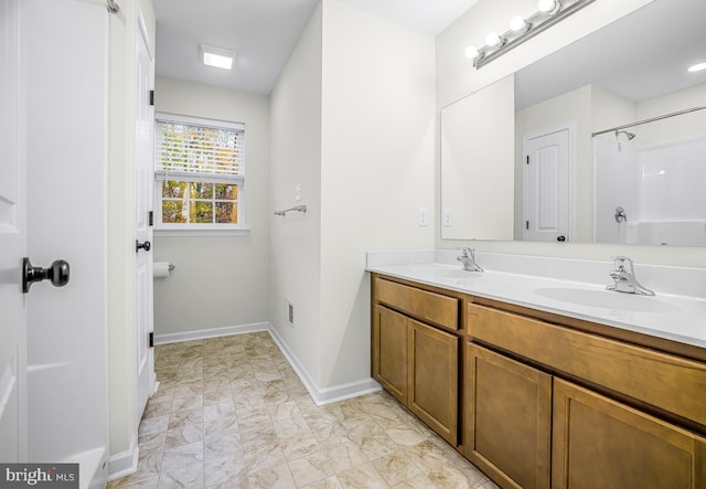 bathroom featuring vanity and a shower