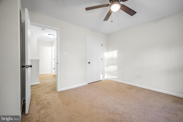 unfurnished bedroom with light colored carpet and ceiling fan