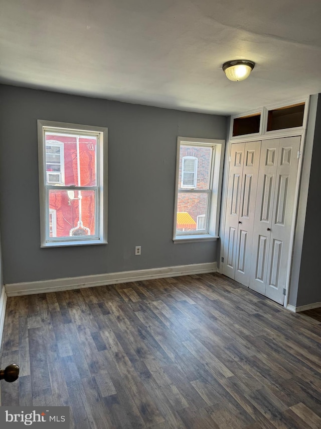 unfurnished bedroom featuring dark hardwood / wood-style flooring