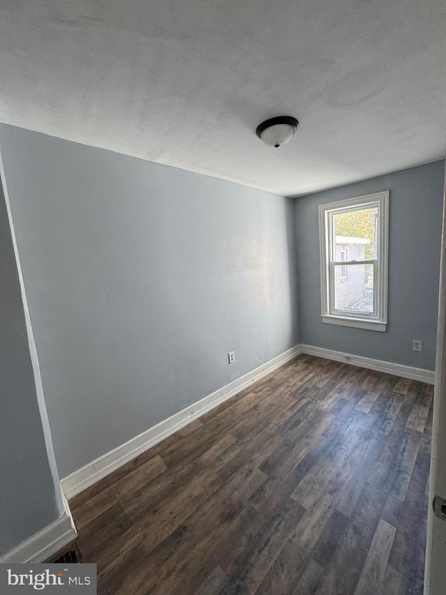 empty room featuring dark hardwood / wood-style floors