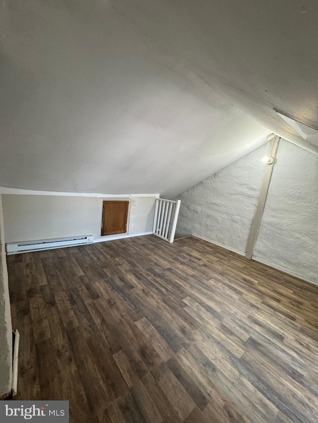 bonus room featuring baseboard heating, dark hardwood / wood-style flooring, and lofted ceiling