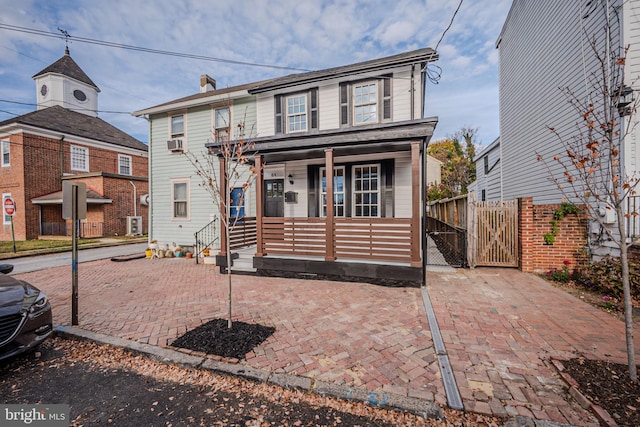 view of front of house with cooling unit and a porch