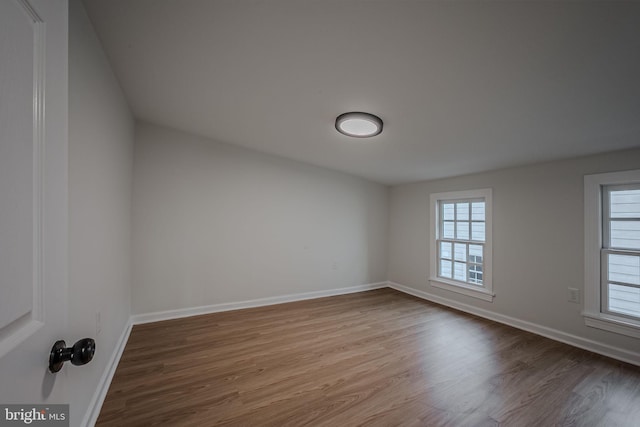 unfurnished room featuring hardwood / wood-style flooring