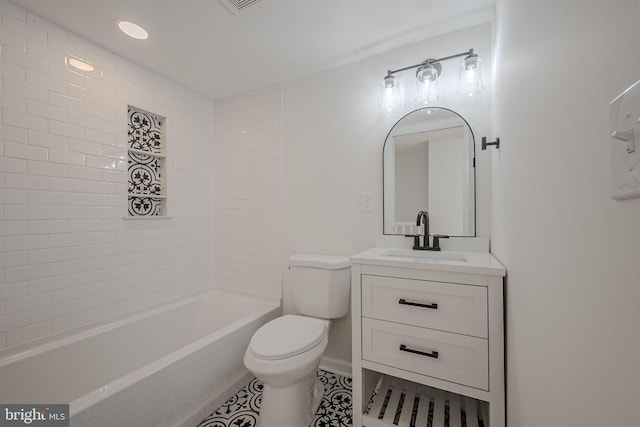 full bathroom featuring tile patterned flooring, vanity, tiled shower / bath combo, and toilet