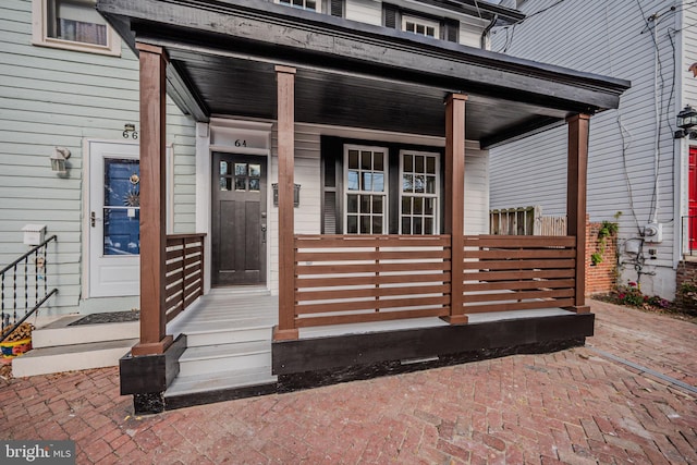 doorway to property featuring covered porch