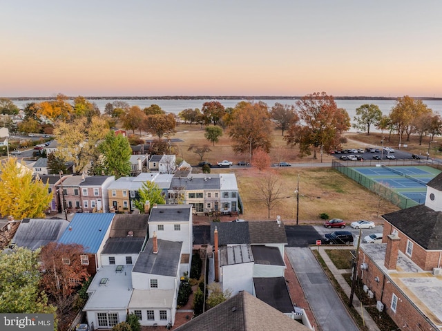 aerial view at dusk with a water view