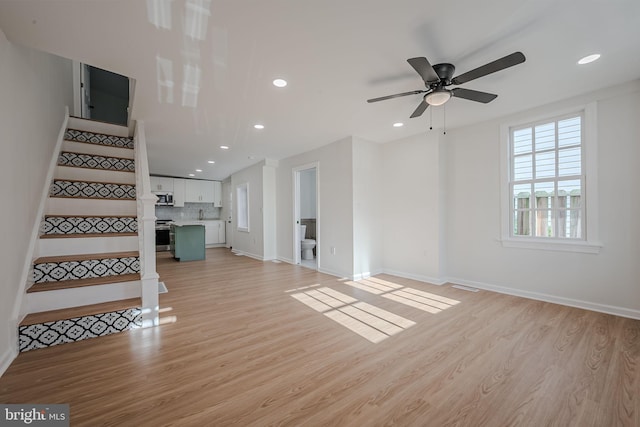 unfurnished living room with light hardwood / wood-style floors and ceiling fan